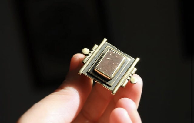 Close-up of La Carré Coco ring in patinated brass set with a hand-cut coconut shell cabochon - Seeds Artisan Creations